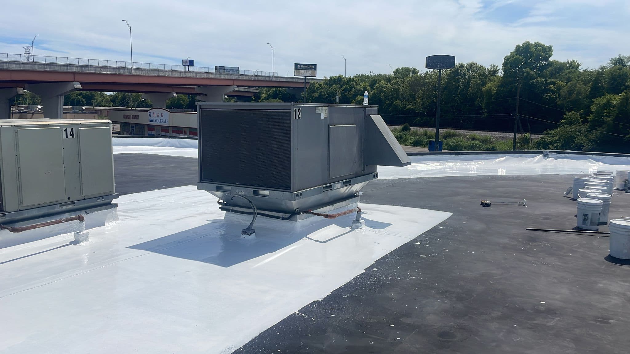 Fresh white TPO membrane installed around HVAC equipment on a commercial roof