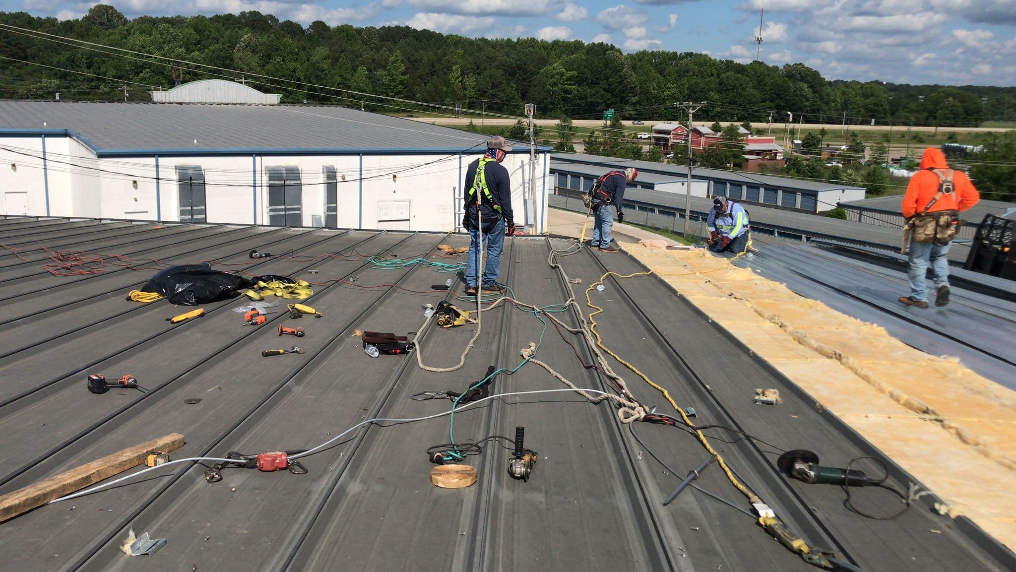 TPO membrane installation on an Atlanta metro office-park roof - phased production minimizes tenant disruption