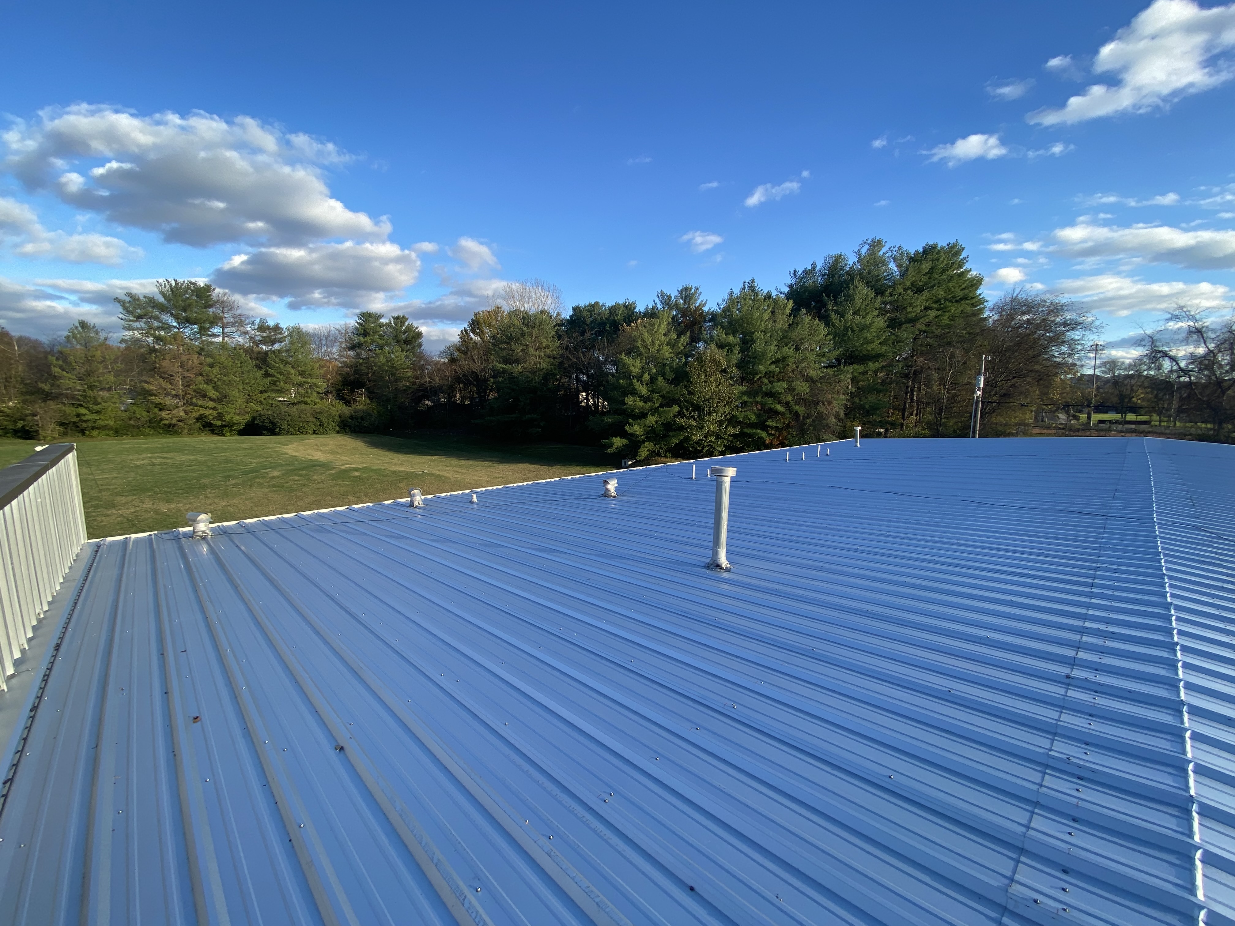 Commercial insurance-claim documentation meeting - adjuster walks the roof with photo-keyed contractor evidence package